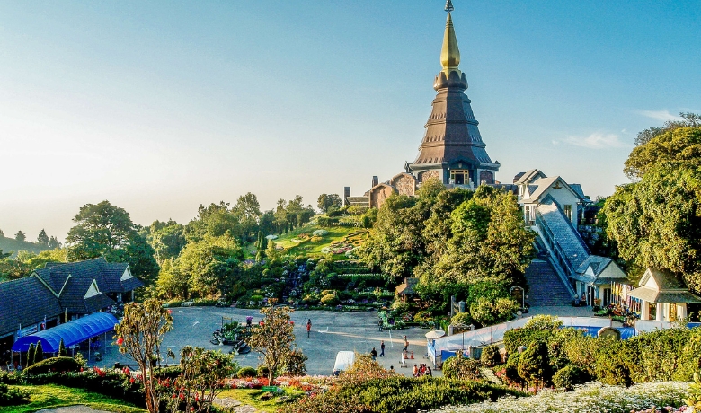 Chiang Mai ancient temples look majestic surrounded by lush green trees and mossy walls.